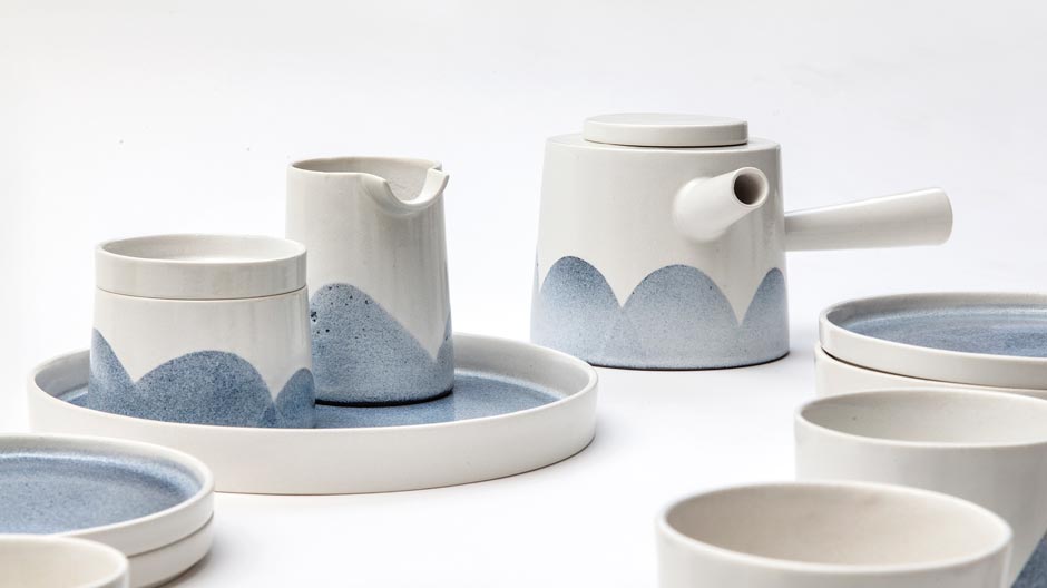 Der dänische Keramiker Lars Renk bringt blaue Wölkchen auf die Keramik-Oberfläche.