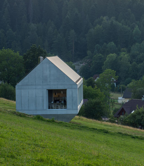 Schwebende Beton-Glas-Skulptur am Hang.